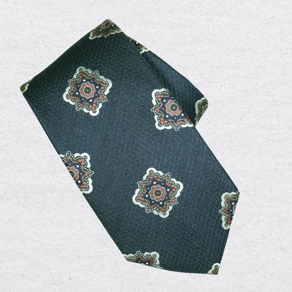 Navy blue tie with patterned rosette designs on a white background