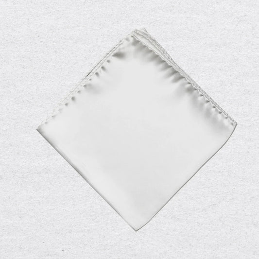 White silk pocket square on a textured grey background