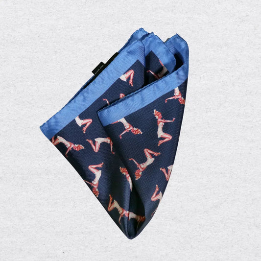 Navy blue silk pocket square with pink pin-up girls, folded on a light grey background