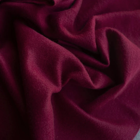 Close-up of burgundy cashemre fabric with folds