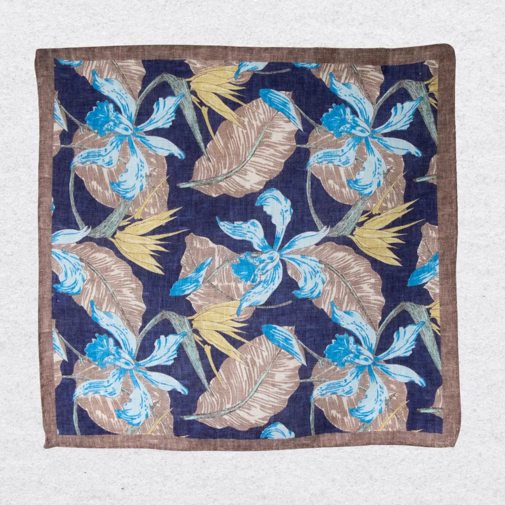 Brown and navy pocket square in linen hanging on a textured  background