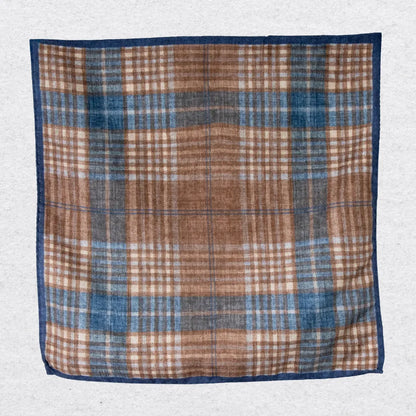 Plaid wool pocket square with brown, blue, and beige colors on a light gray background