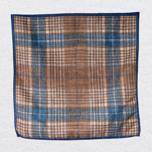 Plaid wool pocket square with brown, blue, and beige colors on a light gray background