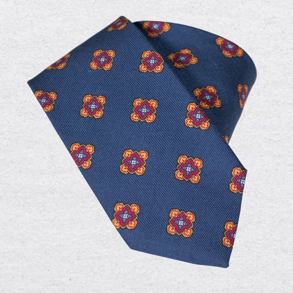 Blue wool-silk tie with colorful floral pattern on a white background