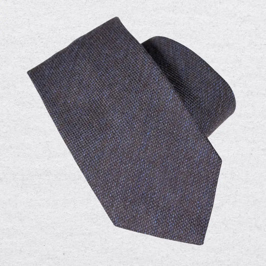 Chocolate brown and navy marle wool-silk tie rolled on a white background