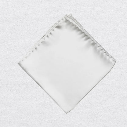 White silk pocket square on a textured grey background