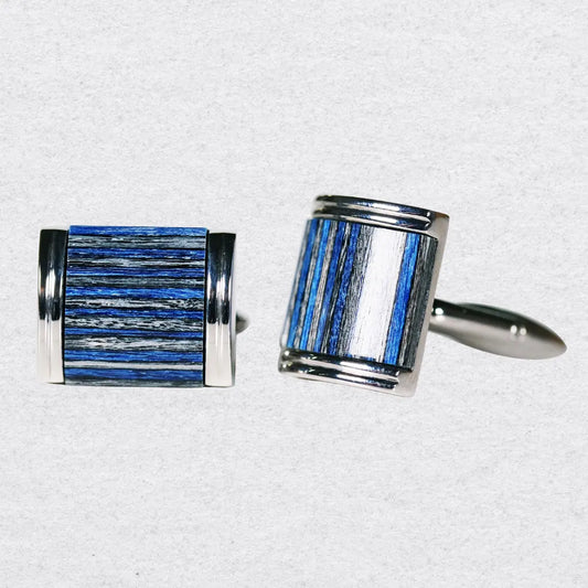 Pair of cufflinks with blue and silver cross-grain design on a grey background