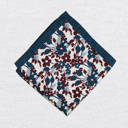 Navy floral patterned silk pocket square on a grey background
