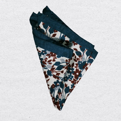 Floral patterned silk pocket square folded on a light grey background
