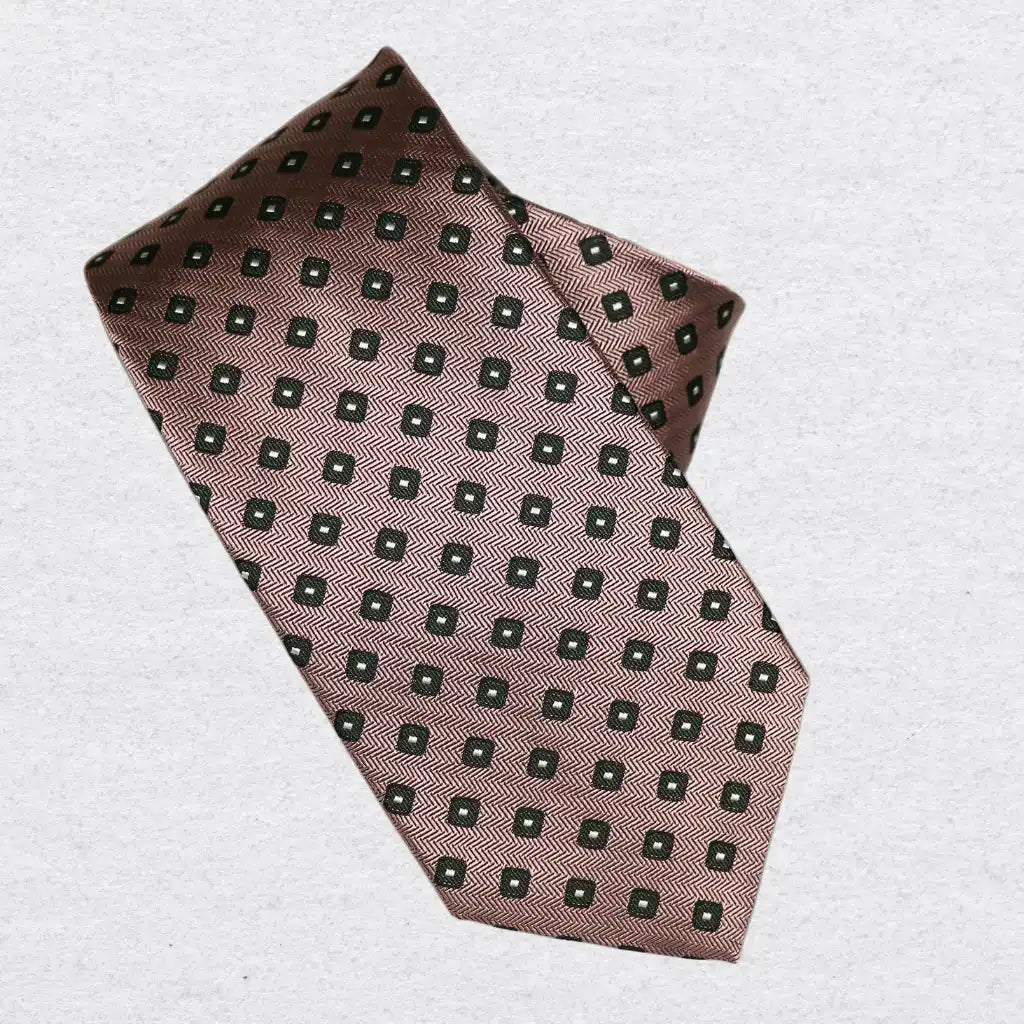 Rose pink tie with forest green pattern, rolled on a white background