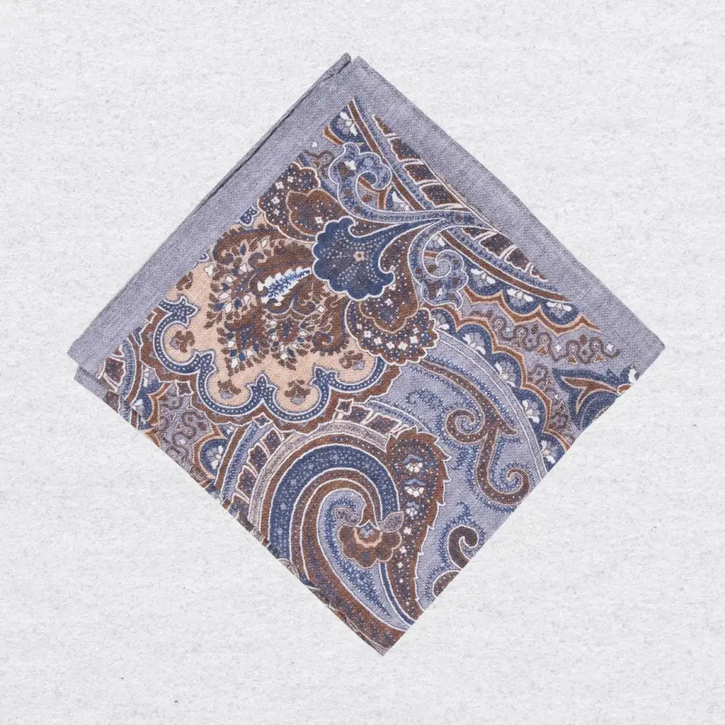 Paisley patterned linen pocket square on a grey background