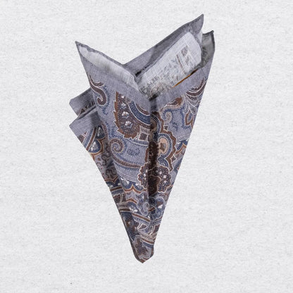 Paisley patterned linen pocket square in grey and tobacco brown on a textured background