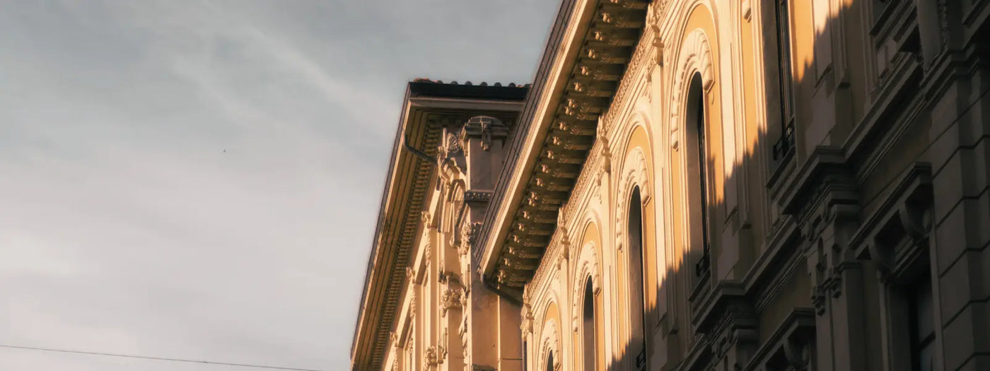 Architectural details of an Italian building with sunlight casting shadows