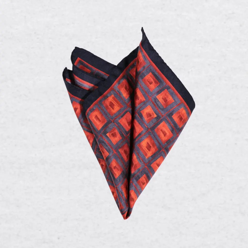 Orange and blue geometric silk pocket square pinched 