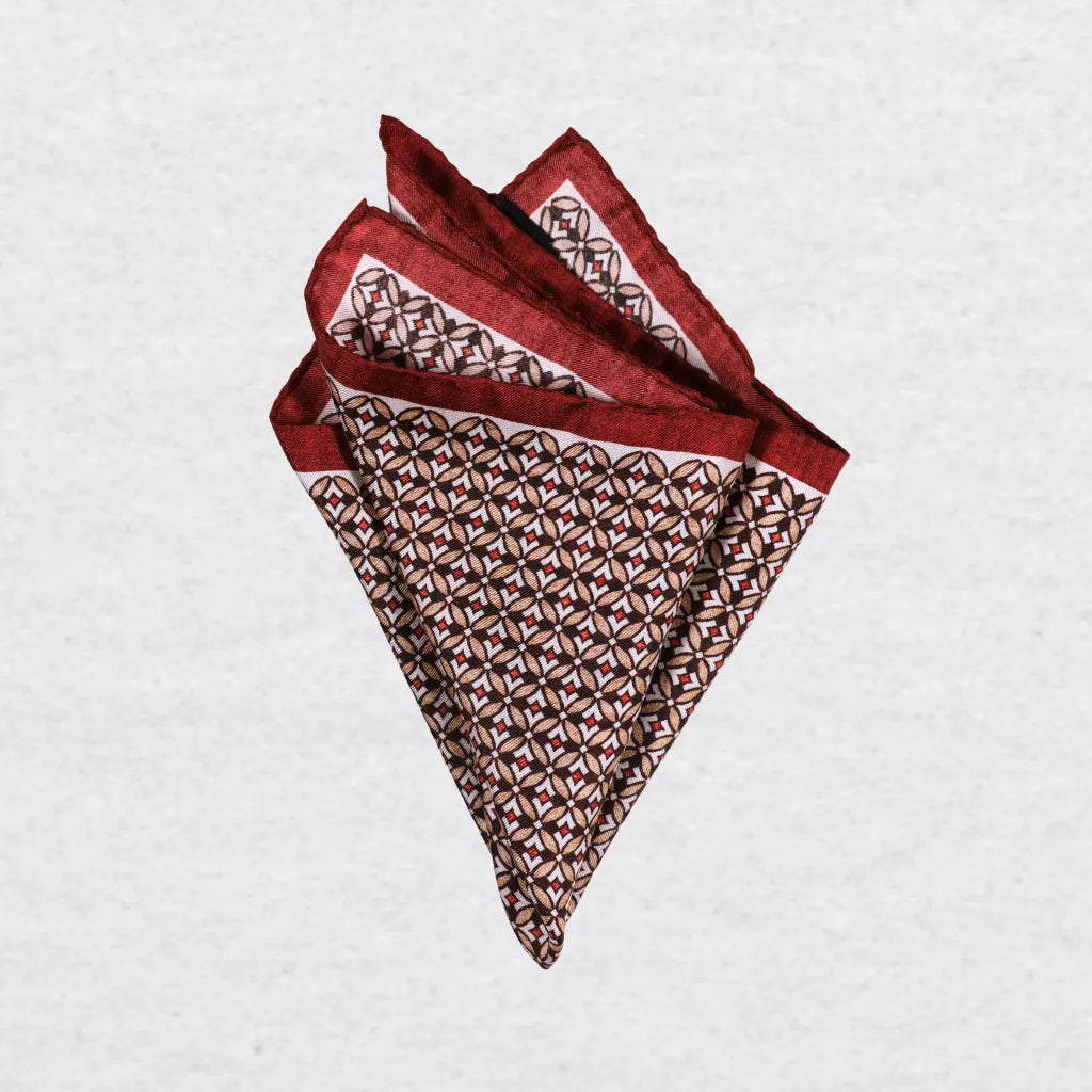 Monti Castello silk pocket square, burnt orange camel geometric, pinched fold	