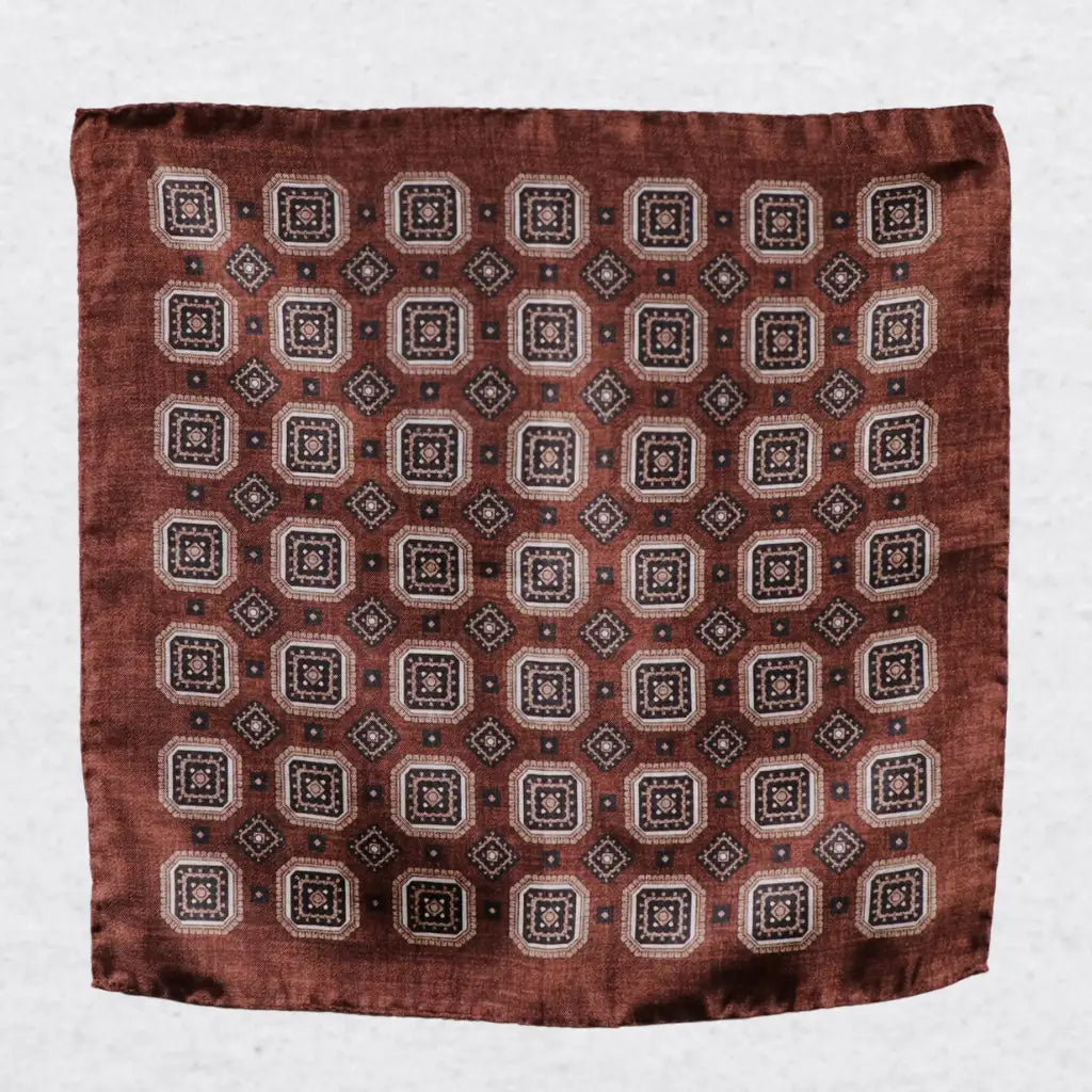 Monti Castello silk pocket square, cinnamon navy square medallion, flat lay
