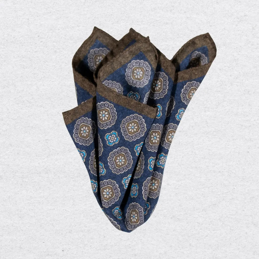 Dark blue wool-silk pocket square with a brown trim and coloured medallions