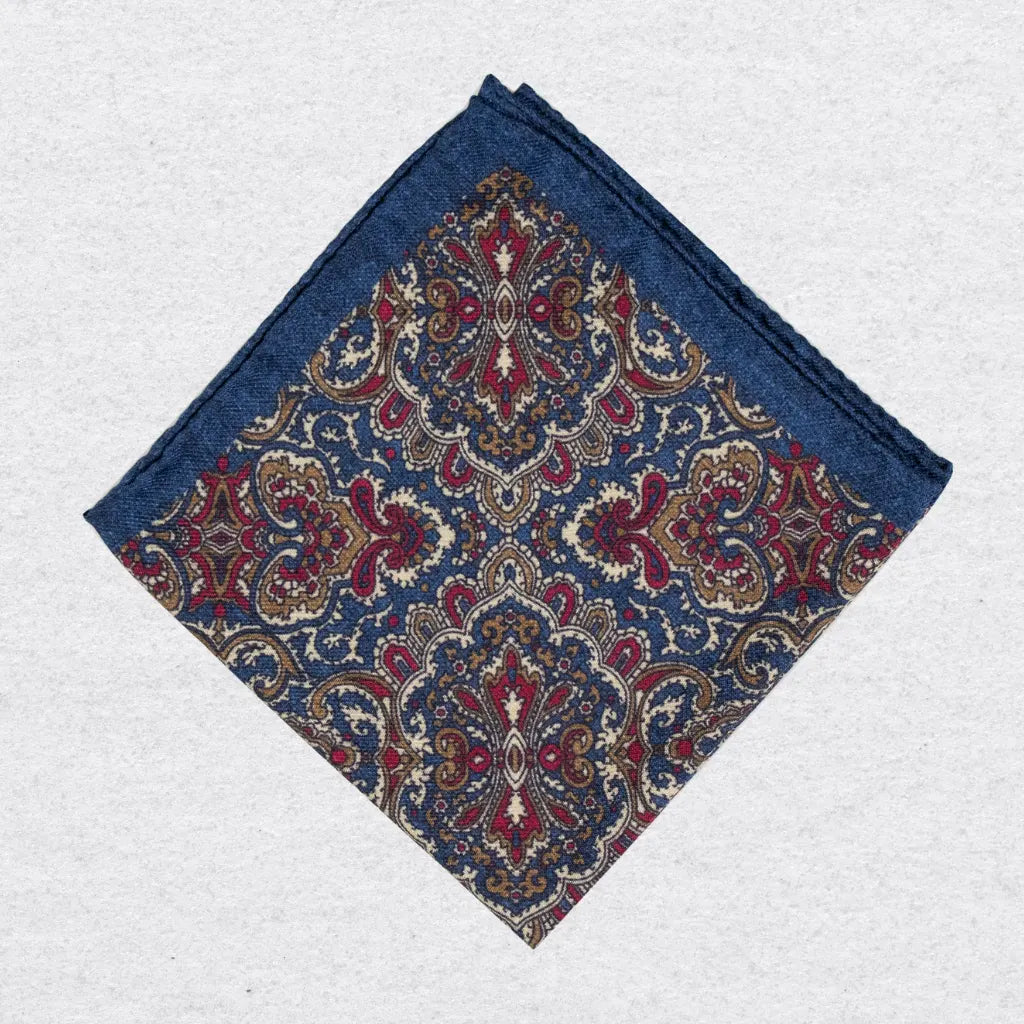 Wool-silk pocket square with intricate paisley pattern on a grey background