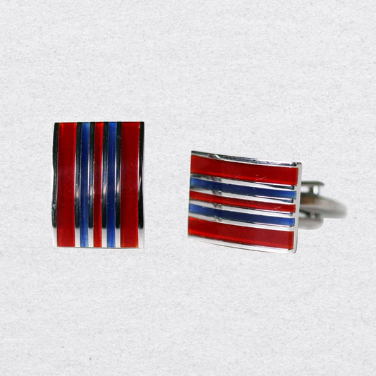 Cufflinks with red, blue, and silver striped design on a grey background