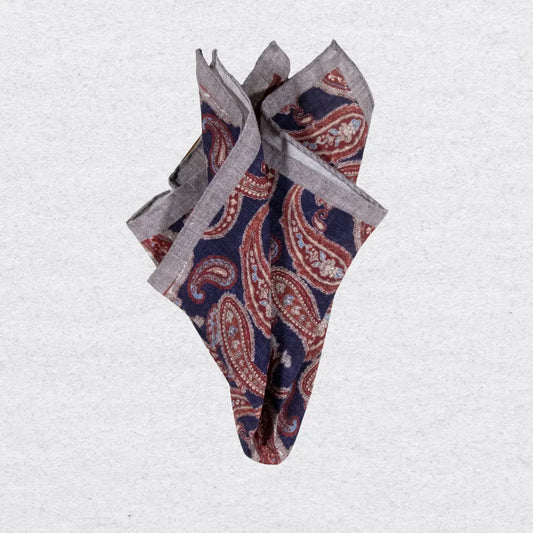 Folded linen pocket square with paisley pattern and grey border on a white background