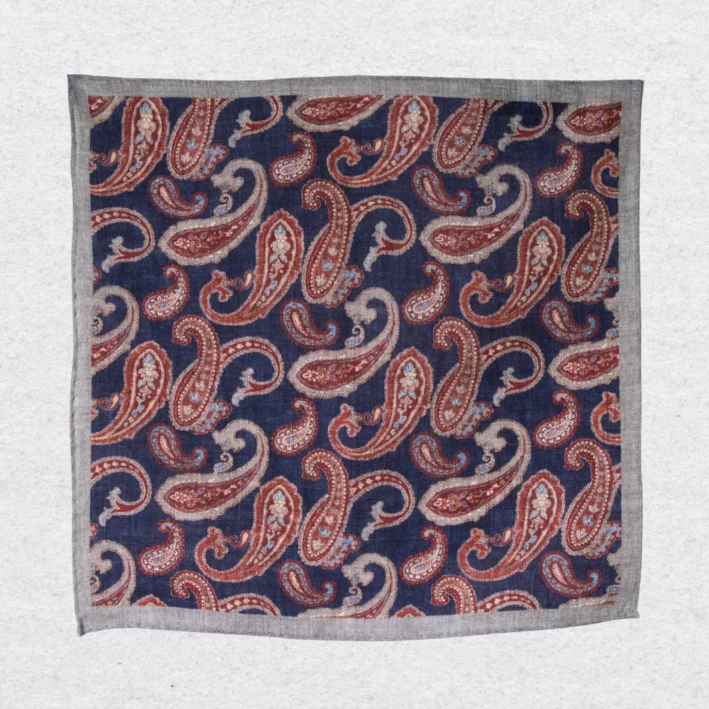 Hanging linen pocket square with paisley pattern and grey border on a white background