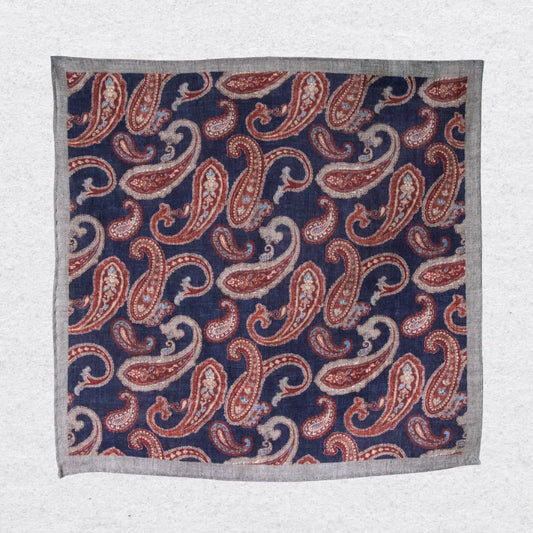 Hanging linen pocket square with paisley pattern and grey border on a white background