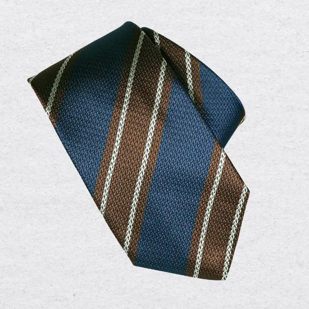 Striped silk tie with blue and cinnamon brown pattern on a white background