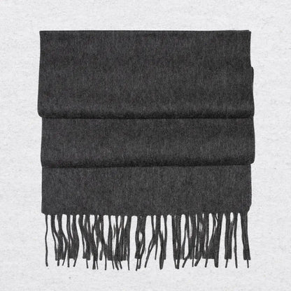Dark gray cashmere scarf with tassels on a light gray background