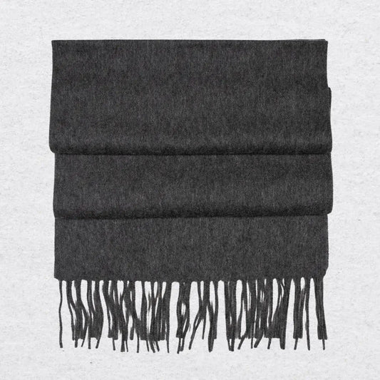 Dark gray cashmere scarf with tassels on a light gray background