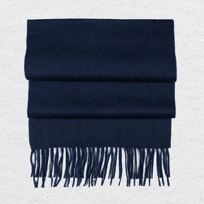 Navy blue cashmere scarf with tassels on a light gray background