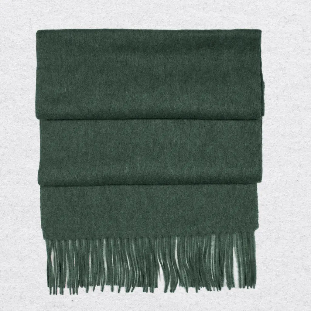 Forest Green cashmere scarf with fringes on a light gray background