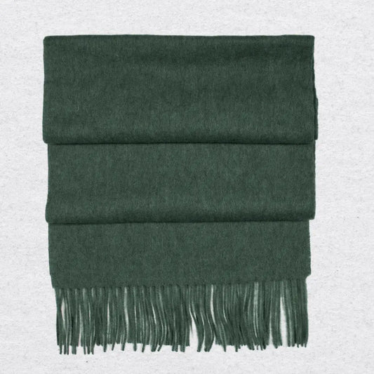 Forest Green cashmere scarf with fringes on a light gray background