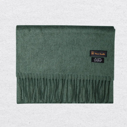 Green cashmere scarf with Monti Castlello brand labels on a light gray background