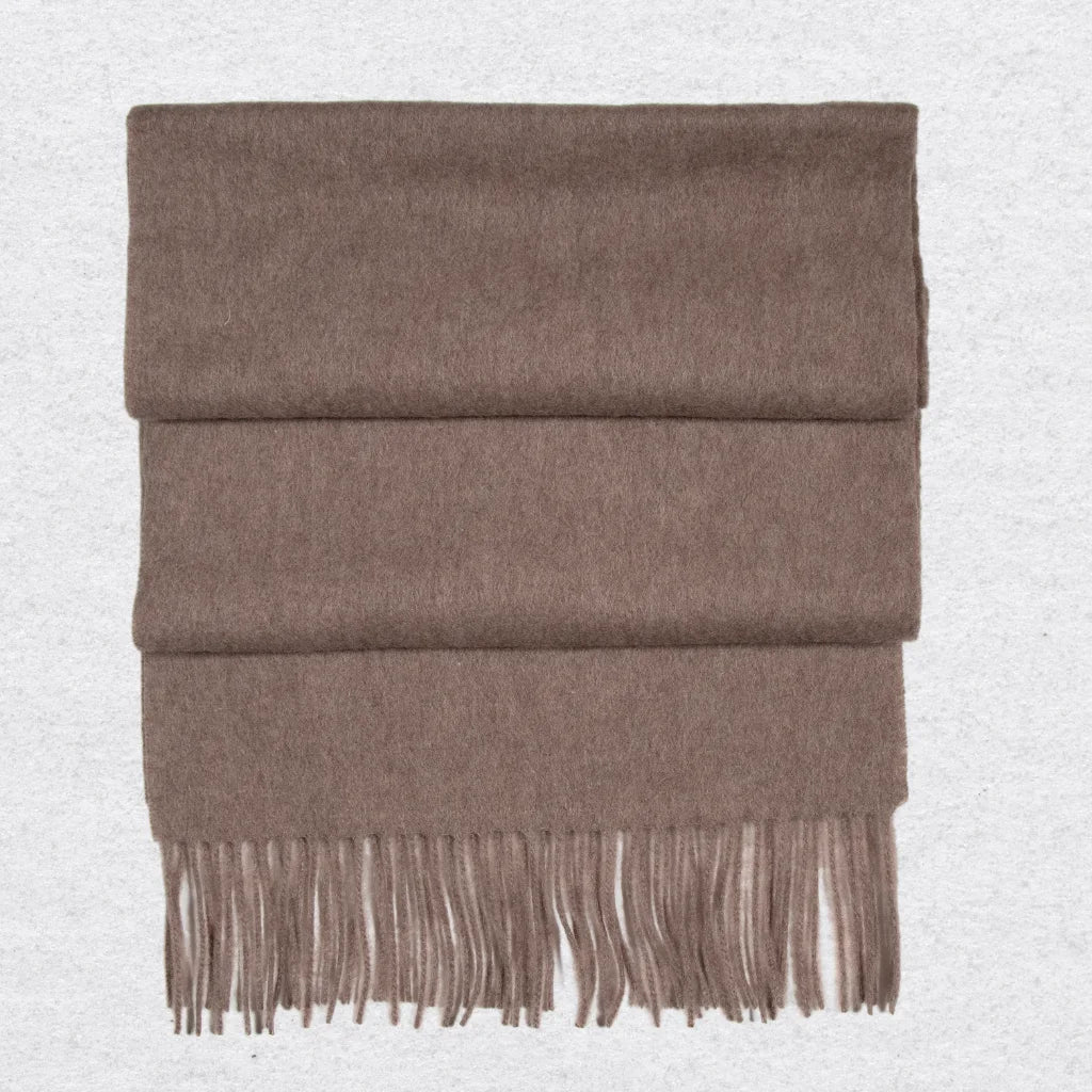 Taupe cashmere scarf against a light grey textured background