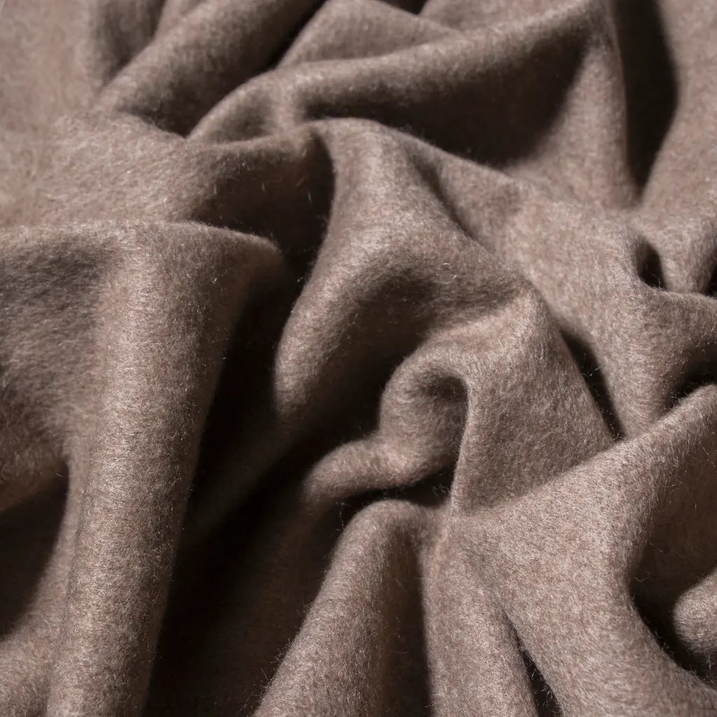 Close-up of taupe cashmere fabric with visible texture