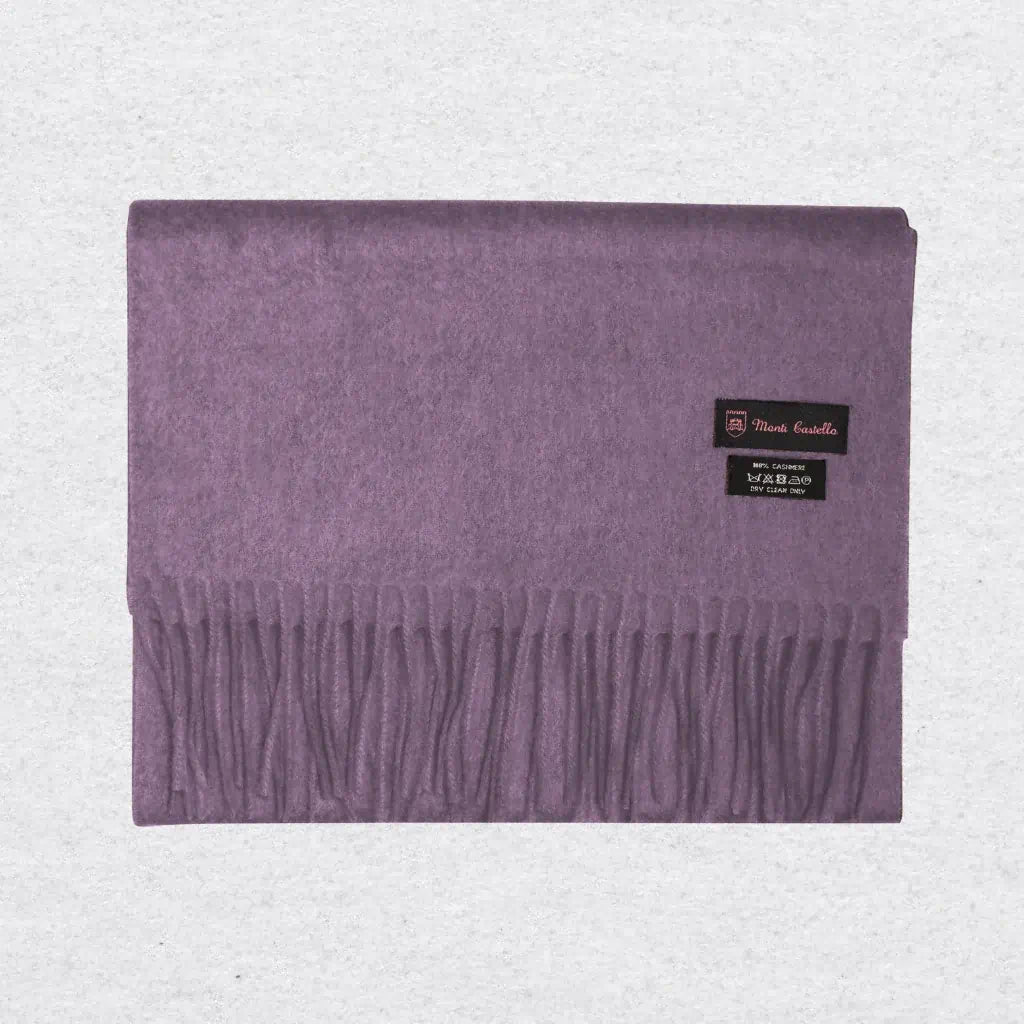Lilac cashmere scarf from Monti Castello on a textured background