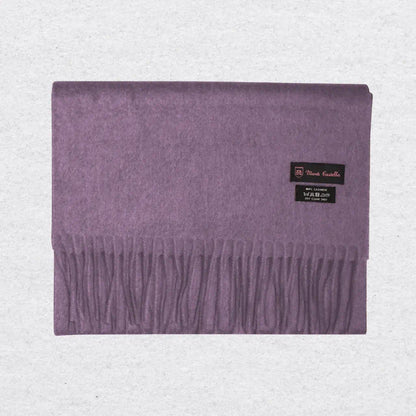 Lilac cashmere scarf from Monti Castello on a textured background
