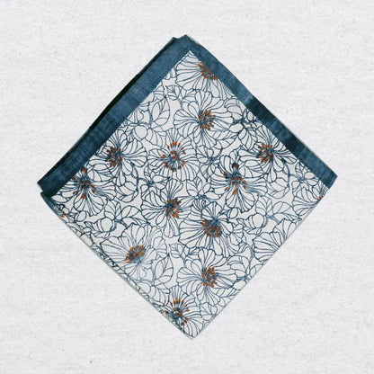 Floral patterned pocket square on a textured grey background