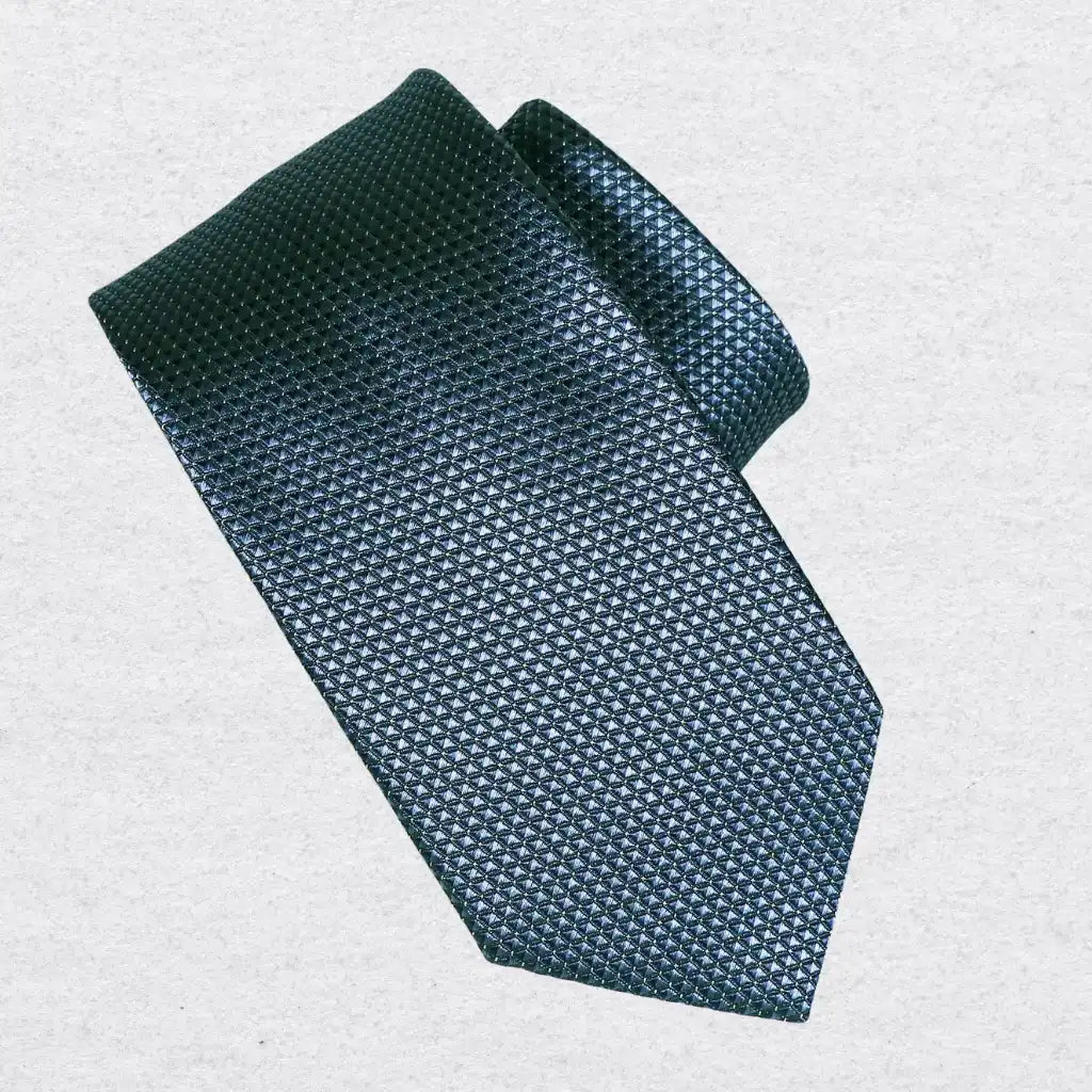 Teal blue pin-dot silk tie rolled on a white background