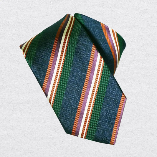 Striped tie with green, orange, and white pattern on a textured background